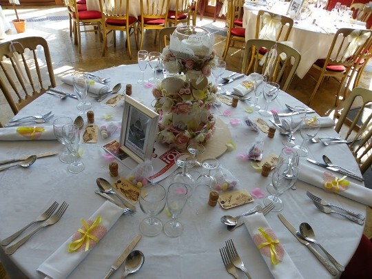 Craig y Nos Castle Wedding Venue table setting with white linen napkins rolled with yellow ribbon 
