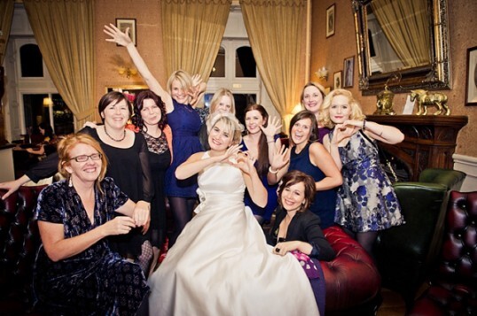 Bride and Guests Celebrate in the Patti Bar at Craig y Nos - photo by Jake Morley Wedding Photography