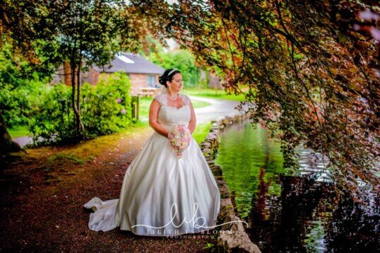 Bride by Craig y Nos Country Park's duck lake Weddings at Craig y Nos Castle South Wales Wedding Venue Country Park's duck lake