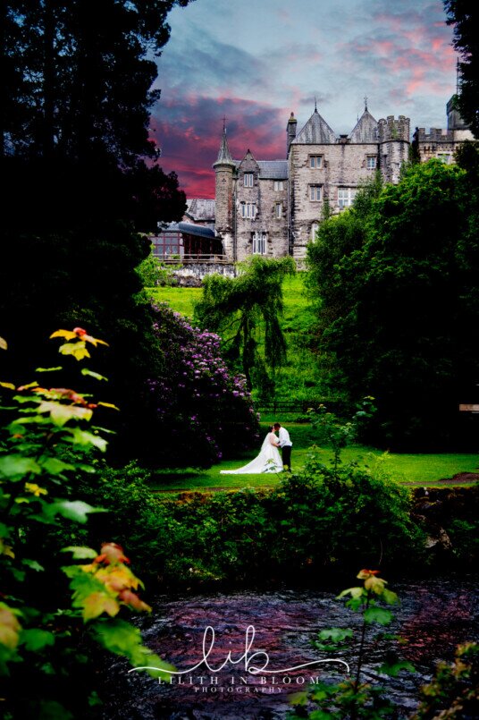 Bridal Couple in Lower Gardens at Craig y Nos Castle viewd from across the river Ceremony Only Weddings Venue South Wales Craig y Nos Castle
