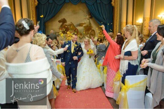 Wedding Couple newly married leaving the Ceremony room at Craig y Nos Castle Castle Wedding Venue Wales Ceremony Room Craig y Nos Castle