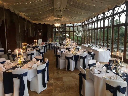 Craig y Nos Castle Wedding Venue with the Conservatory set up for a wedding breakfast blue and white