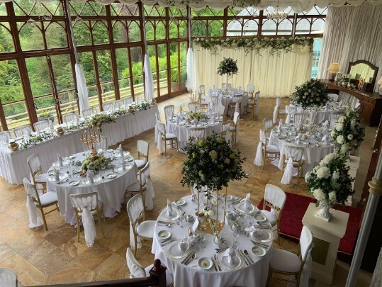 Craig y Nos Castle Wedding Venue Swansea Conservatory Wedding Breakfast pale yellow ribboned chair covers