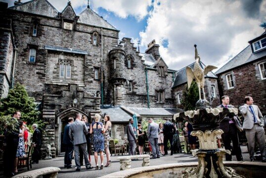 Wedding Party guests in front courtyard of Craig y Nos Castle Weddings at Craig y Nos Castle South Wales Wedding Venue