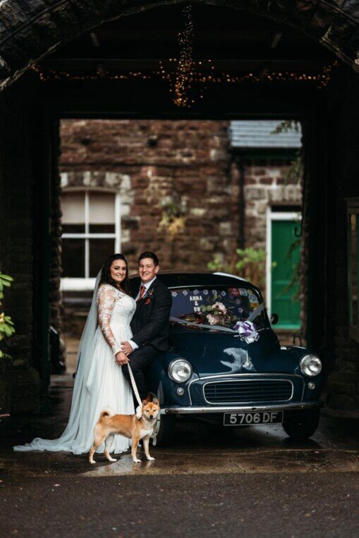 Wedding car and couple with dog Craig y Nos Castle