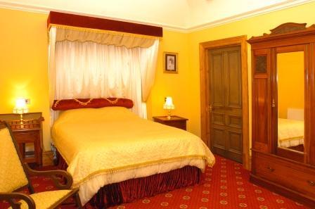 Half Tester gold and red double bed in the Bridal Suite Wedding Venues South Wales - Craig y Nos Castle Accommodation Room Bridal Suite half-tester bed