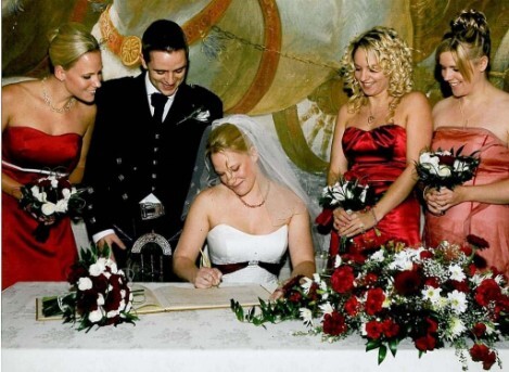 Bride signing the marriage register at Craig y Nos Castle's theatre Wedding Planning Book, Wales Wedding Ceremony in Craig y Nos Castle Theatre