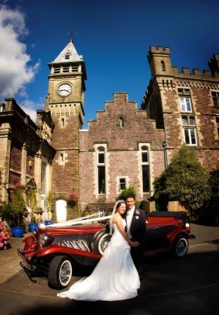 Bride and Groom by red Wedding Car South Wales Wedding Venue Craig y Nos Castle