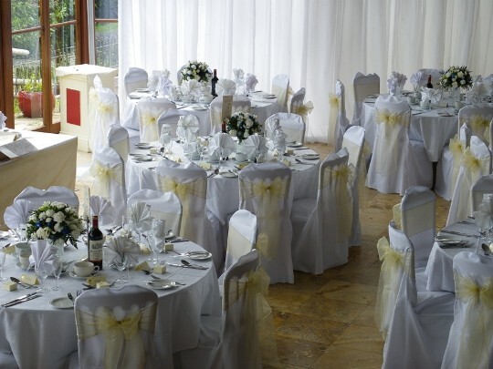 Craig y Nos Castle Wedding Venue Swansea Conservatory Wedding Breakfast pale yellow ribboned chair covers