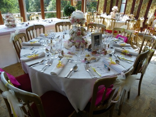 Craig y Nos Castle Wedding Venue in Swansea Valley table setting with rolled table cloths tied wiith yellow ribbon