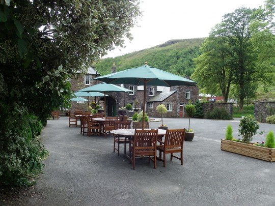 Craig y Nos Castle front car park, left section in front of castle for seating, section on right for car parking Craig y Nos Castle Wedding Venue Front Courtyard garden tables and chairs