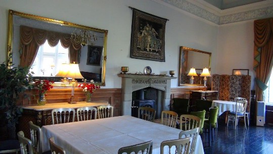 A more recent picture of the music room at Craig y Nos Castle with the new table lamps in front of mirrors Craig y Nos Castle Wedding Venue the Music Room and stone fireplace