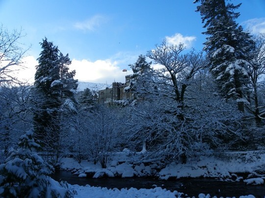 Craig y Nos Castle Winter snow in country park, snow covered banks of river Tawe