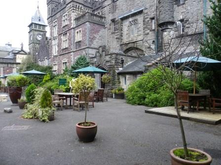 Craig y Nos Castle Front Courtyard with plant pots and tables and chairs for outside drinks and seating Wedding Venues South Wales - Craig y Nos Castle Front Courtyard